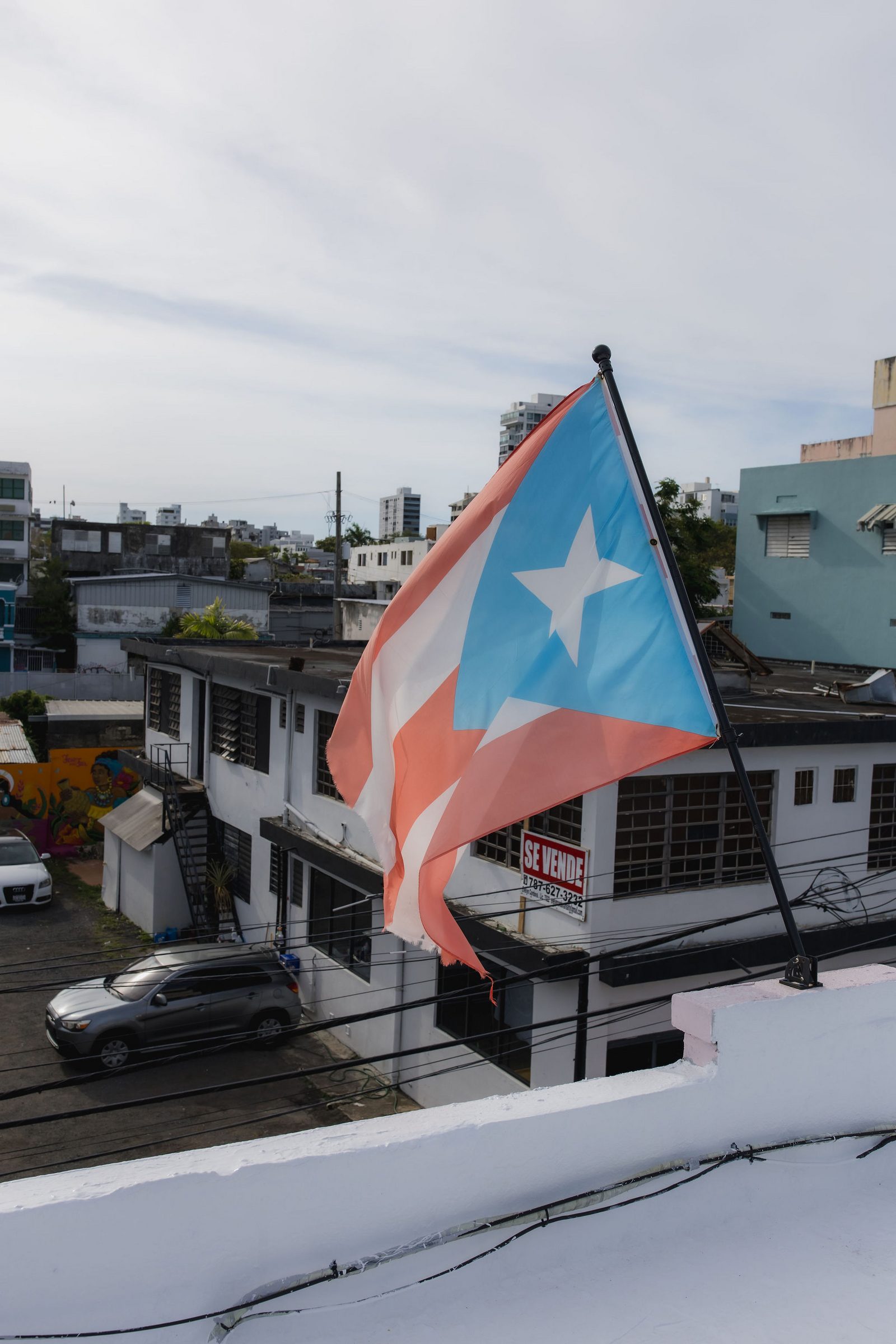Puerto Rican flag on the Hotel Luz rooftop overlooking the Santurce streetscape